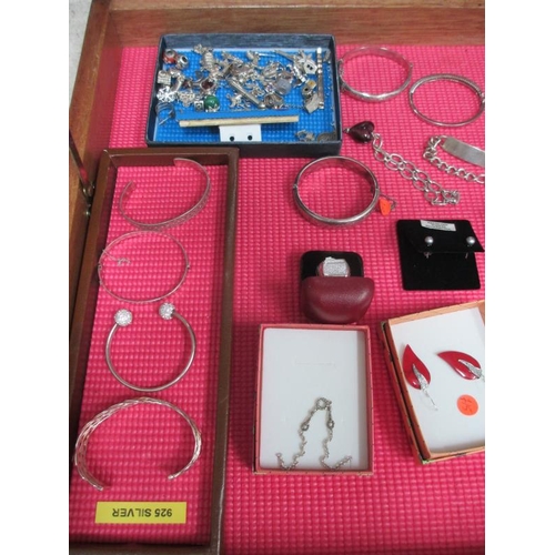 644 - A display case of silver bangles, charms, earrings etc., (this lot is buyer collect only).