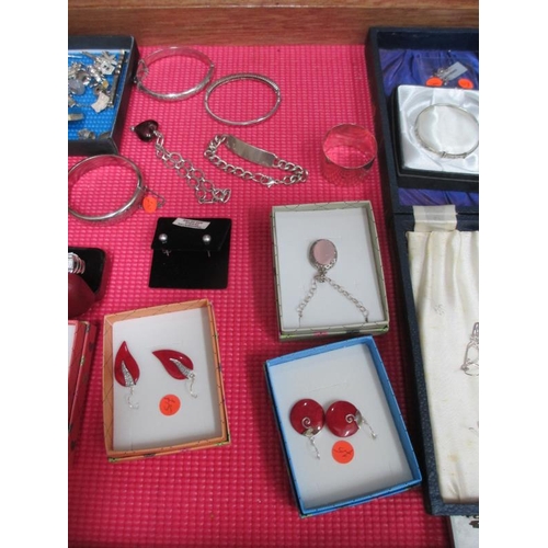 644 - A display case of silver bangles, charms, earrings etc., (this lot is buyer collect only).