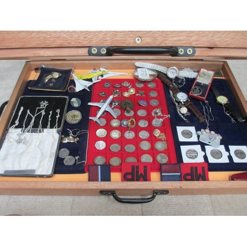 646 - A display case containing silver chains, assorted coins, model aircraft, watches, cloth badges etc. ... 