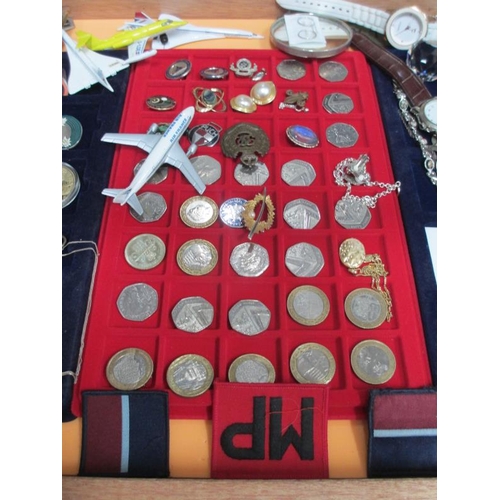 646 - A display case containing silver chains, assorted coins, model aircraft, watches, cloth badges etc. ... 