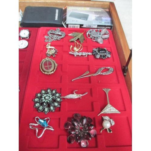 649 - A display case containing assorted jewellery and watches etc., (this lot is buyer collect only).