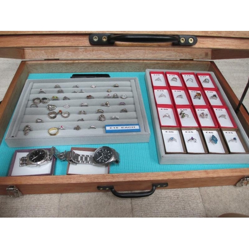 650 - A display case containing in excess of 50 silver rings and 2 gent's wrist watches. (this lot is buye... 