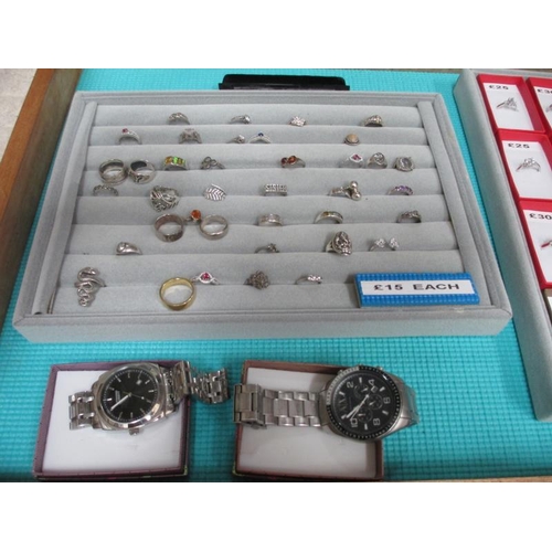 650 - A display case containing in excess of 50 silver rings and 2 gent's wrist watches. (this lot is buye... 