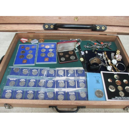 655 - A display case containing miscellaneous coins, watches, medals etc.,