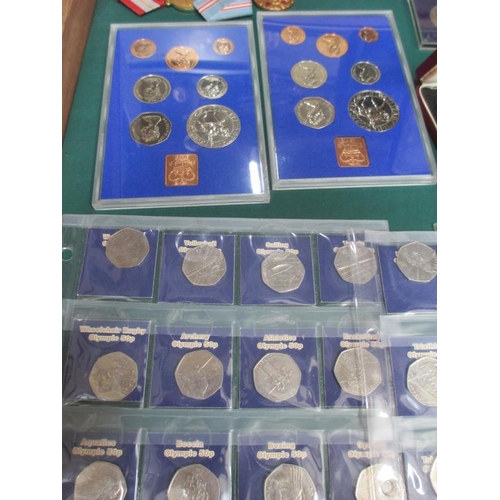 655 - A display case containing miscellaneous coins, watches, medals etc.,