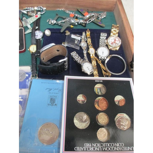 655 - A display case containing miscellaneous coins, watches, medals etc.,