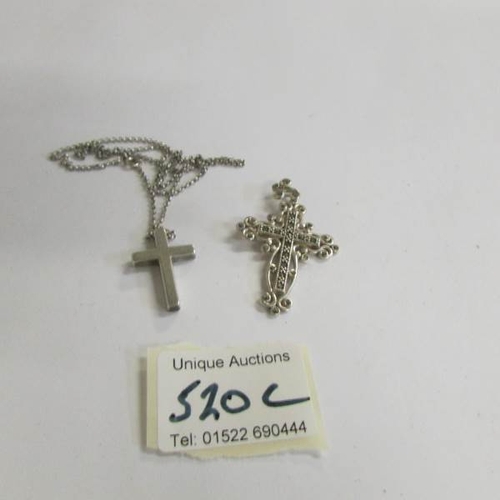 520C - A silver cross on chain and a silver marcasite cross.