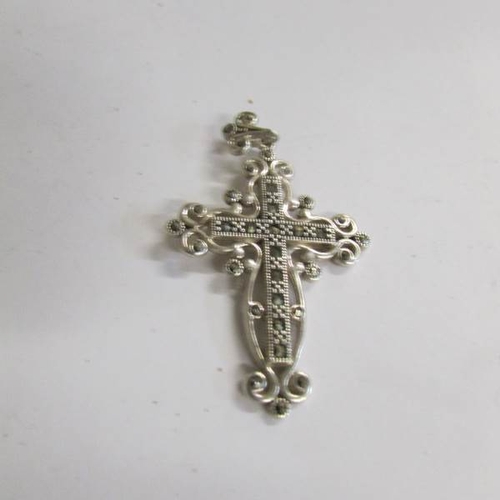 520C - A silver cross on chain and a silver marcasite cross.