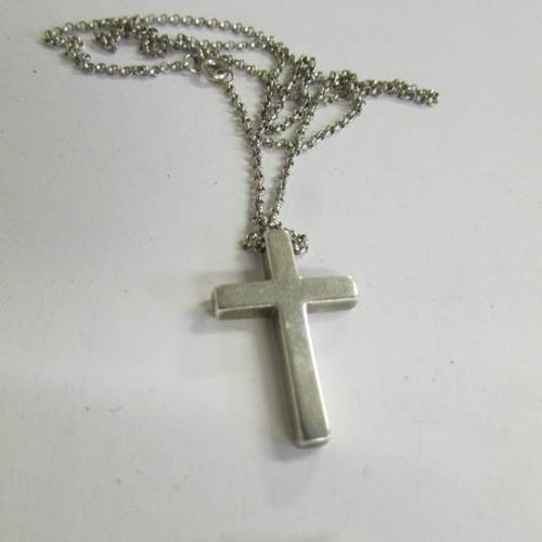 520C - A silver cross on chain and a silver marcasite cross.