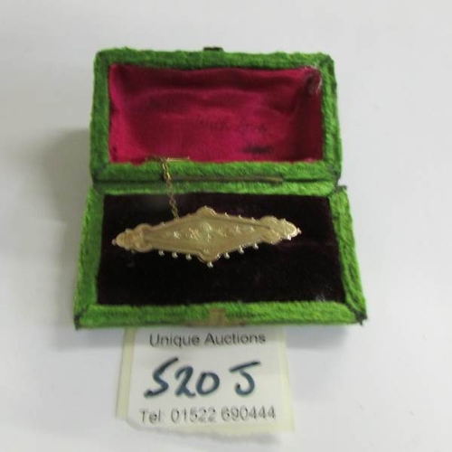 520J - A 3 gram Chester hall mark yellow gold brooch in satin box.