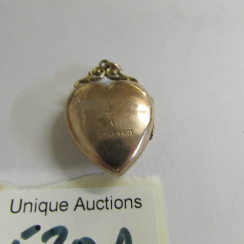 520P - A 9ct see through heart locket, 6.4 grams.