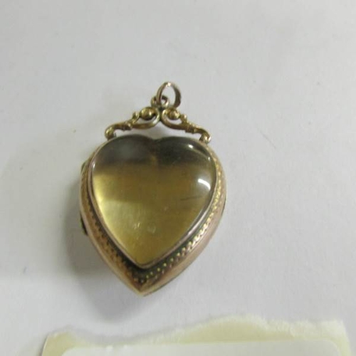 520P - A 9ct see through heart locket, 6.4 grams.