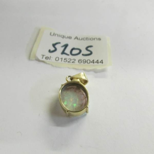 520S - A 14ct yellow gold and opal pendant.