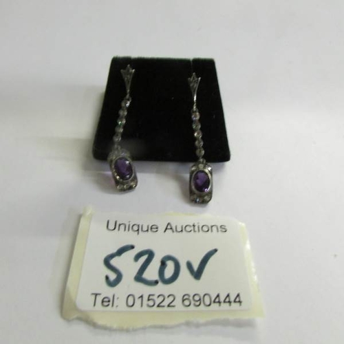 520V - A pair of amethyst and diamond drop earrings.