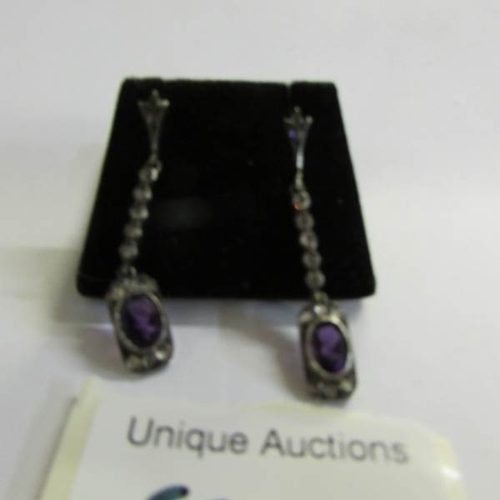 520V - A pair of amethyst and diamond drop earrings.