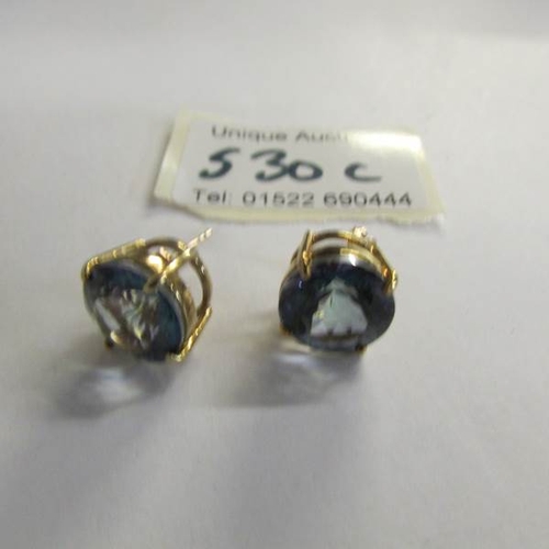 530C - A pair of yellow gold and topaz earrings.