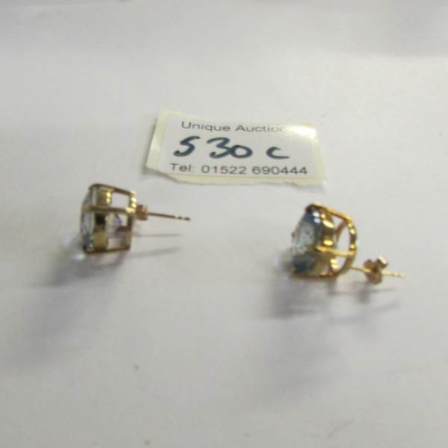 530C - A pair of yellow gold and topaz earrings.