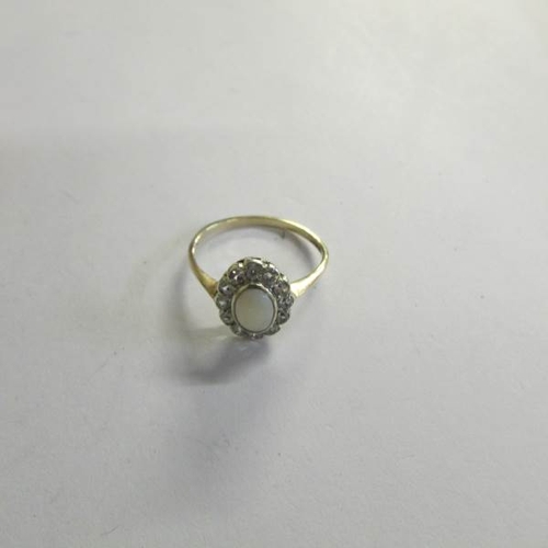 530E - A yellow gold opal and diamond ring, size T.