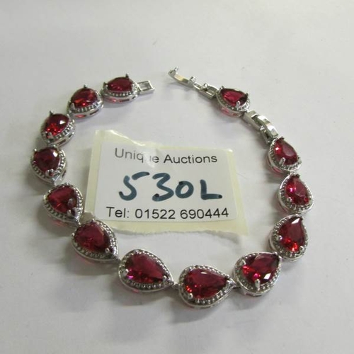 530L - A silver garnet bracelet.