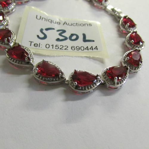 530L - A silver garnet bracelet.