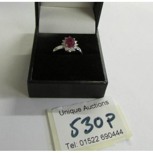 530P - An 18ct gold ruby and diamond ring (Ruby 125, diamond 70pt) size M half.