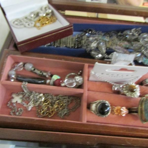 530R - A jewellery box and contents to include pendants, bracelets, rings etc.,