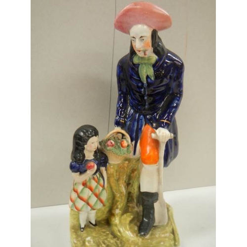 768 - A Victorian Staffordshire figure of a farmer with a young girl.