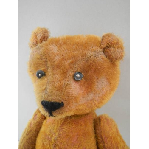 779 - A straw filled Teddy bear, 15'' long, in fair condition.