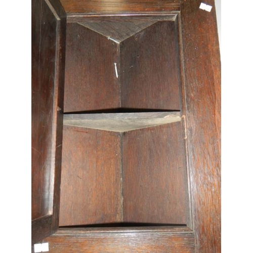 785 - An early 20th century carved oak corner cupboard, 30'' tall.