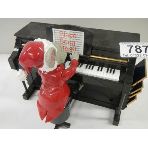 787 - A battery operated mouse playing a piano with 7 tune sheets that are inserted in the back for him to... 