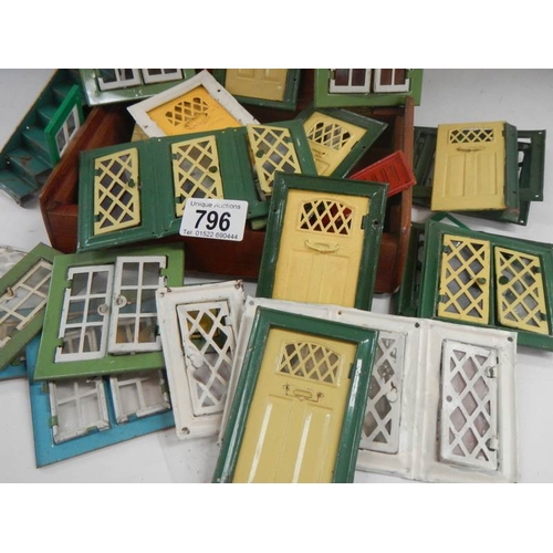 796 - A good lot of vintage metal dolls house doors and windows.