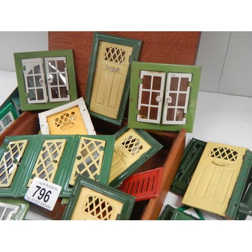 796 - A good lot of vintage metal dolls house doors and windows.