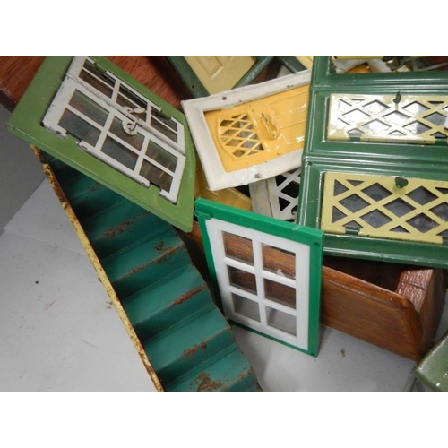 796 - A good lot of vintage metal dolls house doors and windows.