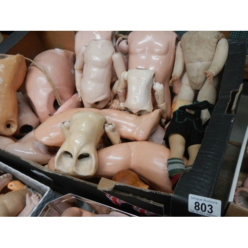 803 - A large mixed lot of doll parts including arms, legs. torsos etc.,