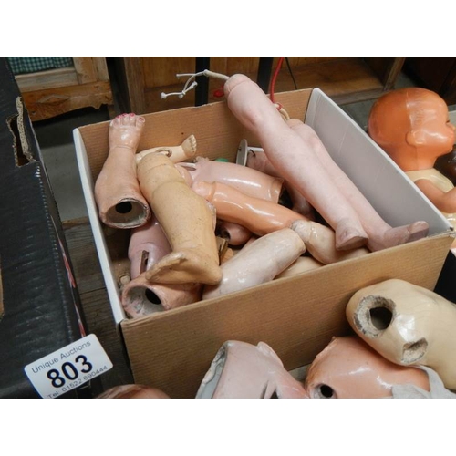 803 - A large mixed lot of doll parts including arms, legs. torsos etc.,