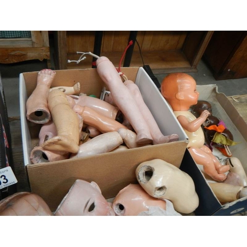 803 - A large mixed lot of doll parts including arms, legs. torsos etc.,