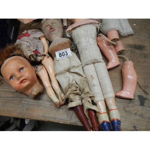 803 - A large mixed lot of doll parts including arms, legs. torsos etc.,