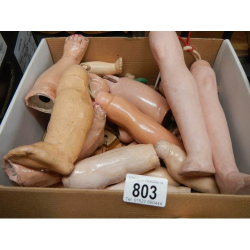 803 - A large mixed lot of doll parts including arms, legs. torsos etc.,