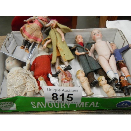 815 - A tray of small porcelain dolls etc,,