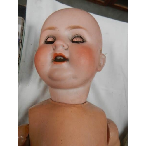 816 - A large Victorian porcelain headed doll, needs wig, 23'' tall.