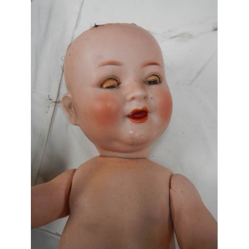 818 - A 15'' Victorian porcelain headed doll, 15'' tall.