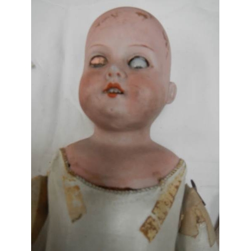 819 - A Victorian porcelain headed doll with kid body, needs wig, 20'' tall.