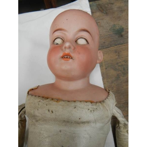 820 - A Victorian porcelain headed doll with kid body, needs wig, 22'' tall.