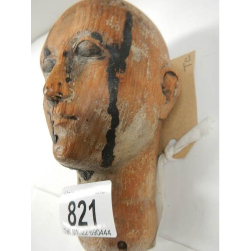 821 - A Victorian carved wood dolls head.