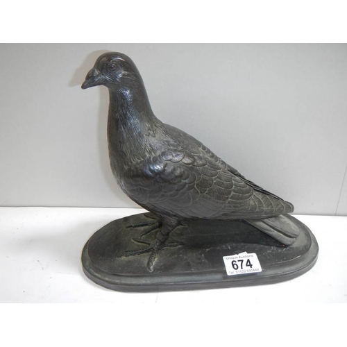 674 - A model of a pigeon signed T Rynharl, in a bronze coloured finish.