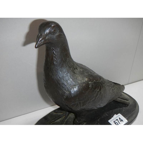 674 - A model of a pigeon signed T Rynharl, in a bronze coloured finish.