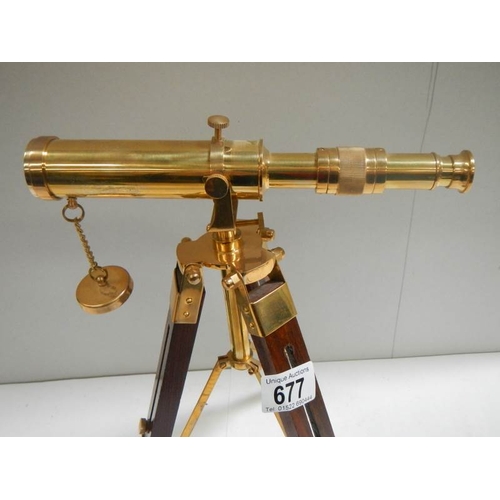 677 - A 20th century brass telescope on adjustable stand, height 15''.