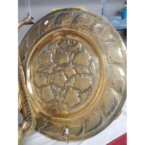 679 - 2 large brass plates and a 22'' tall brass jug.