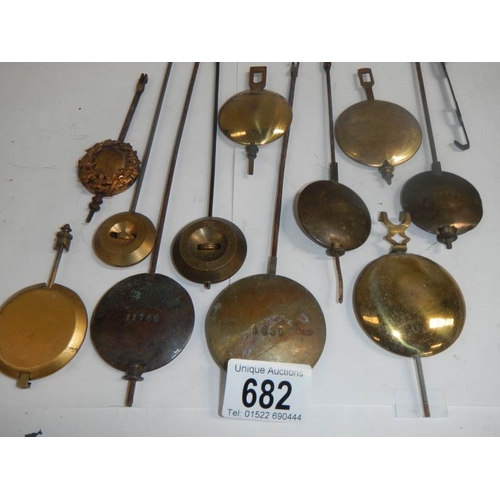 682 - A mixed lot of old clock pendulums.