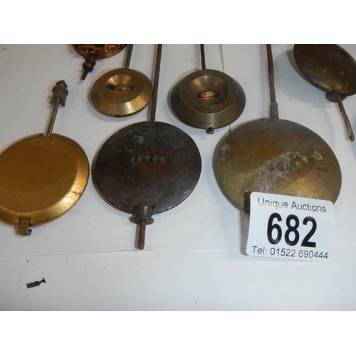 682 - A mixed lot of old clock pendulums.